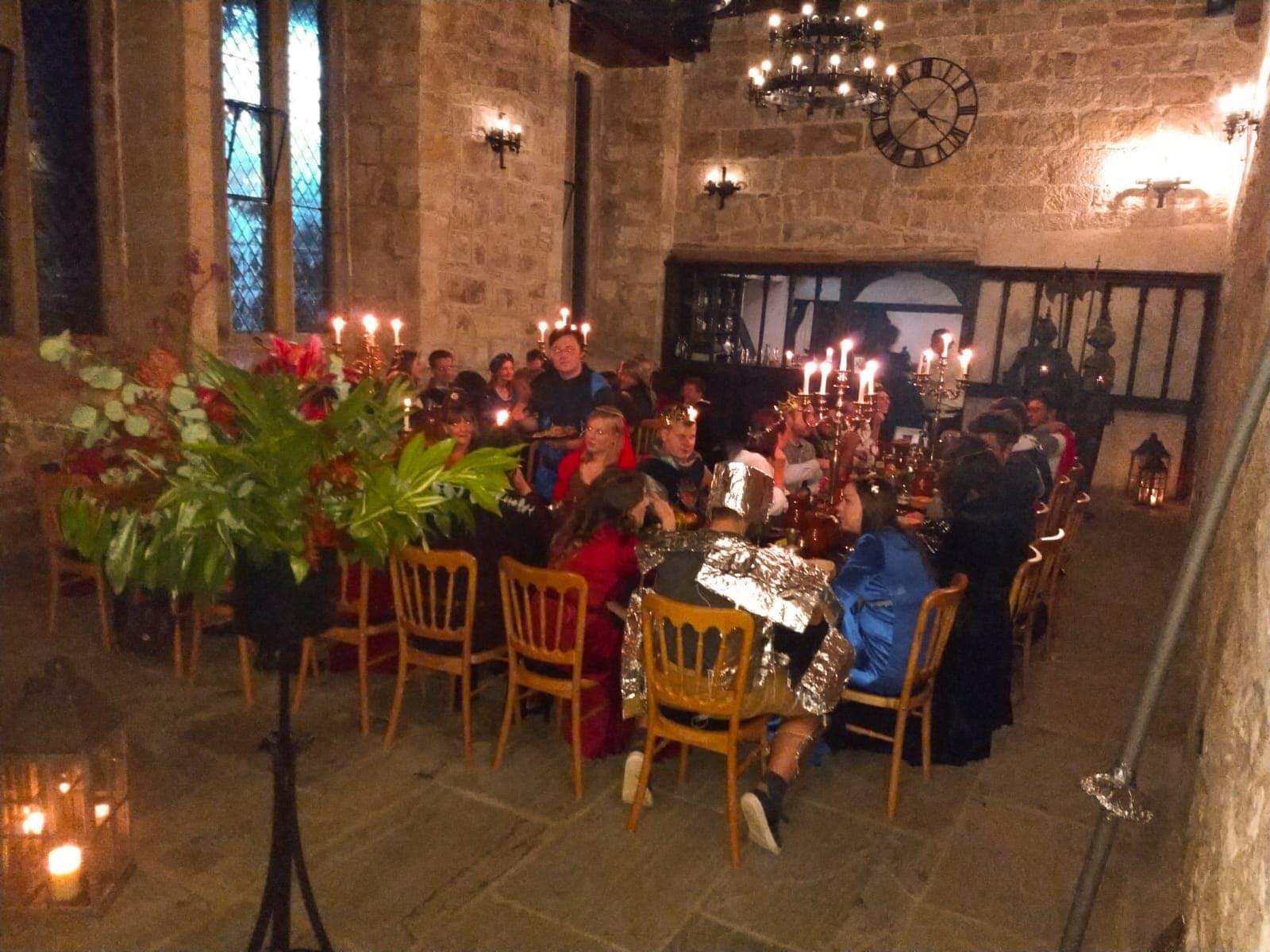 Medieval Chapel set-up with red floral pieces.